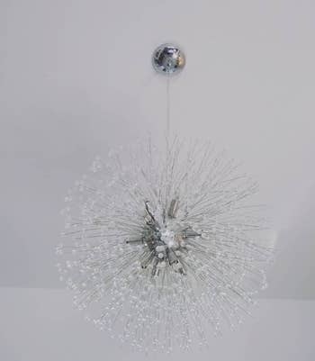 A modern sputnik style chandelier with clear crystal rods, suitable for contemporary home decor shopping