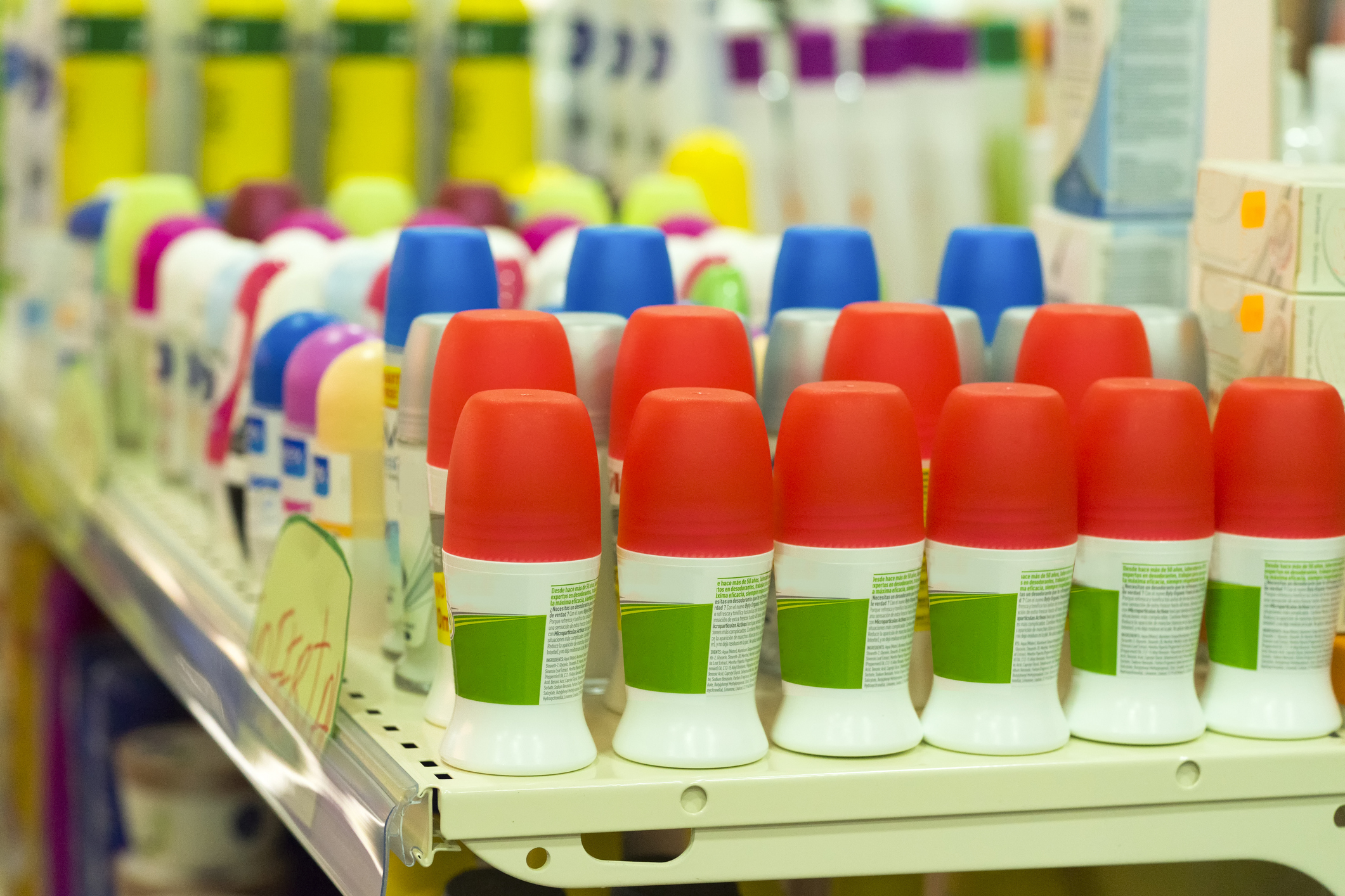 Shelves stocked with various deodorant bottles in a store