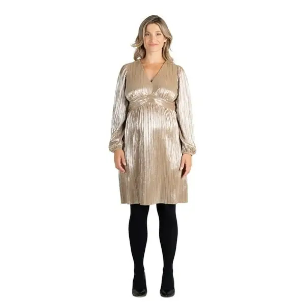 Model in metallic pleated maternity dress with black tights and heels