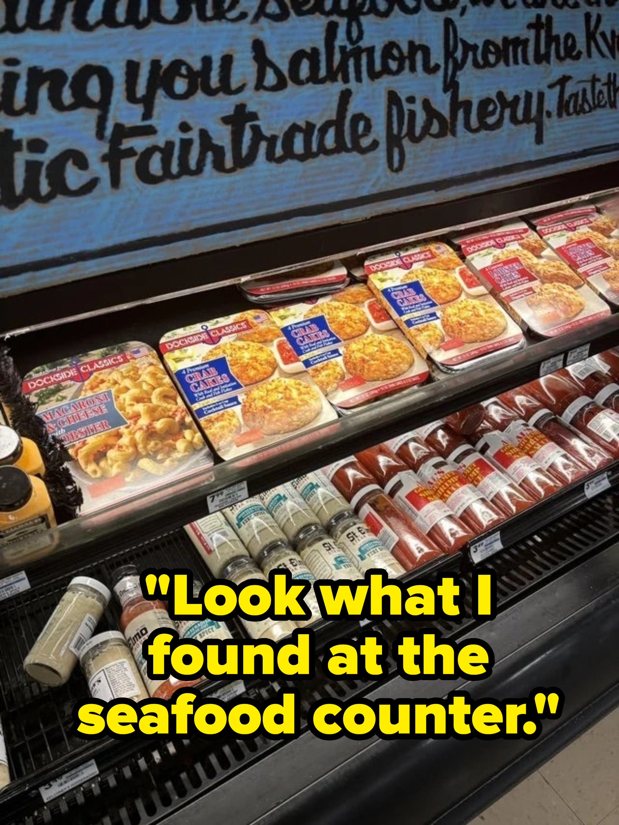 Supermarket shelf stocked with packaged seafood products including the premade dockside classics crab cakes
