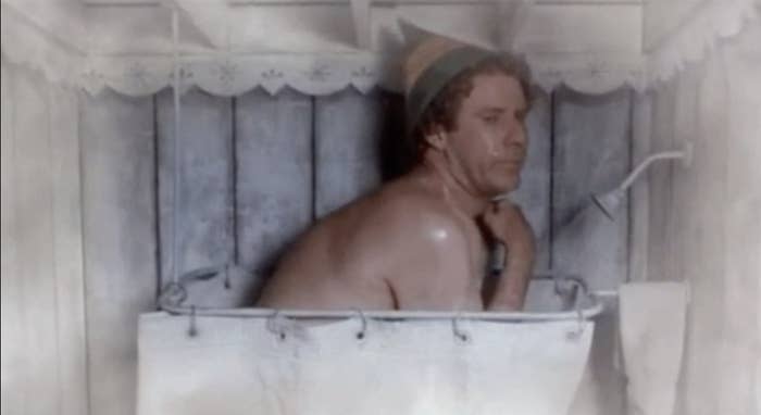 Man in a makeshift bath, looking pensive with makeshift headwear