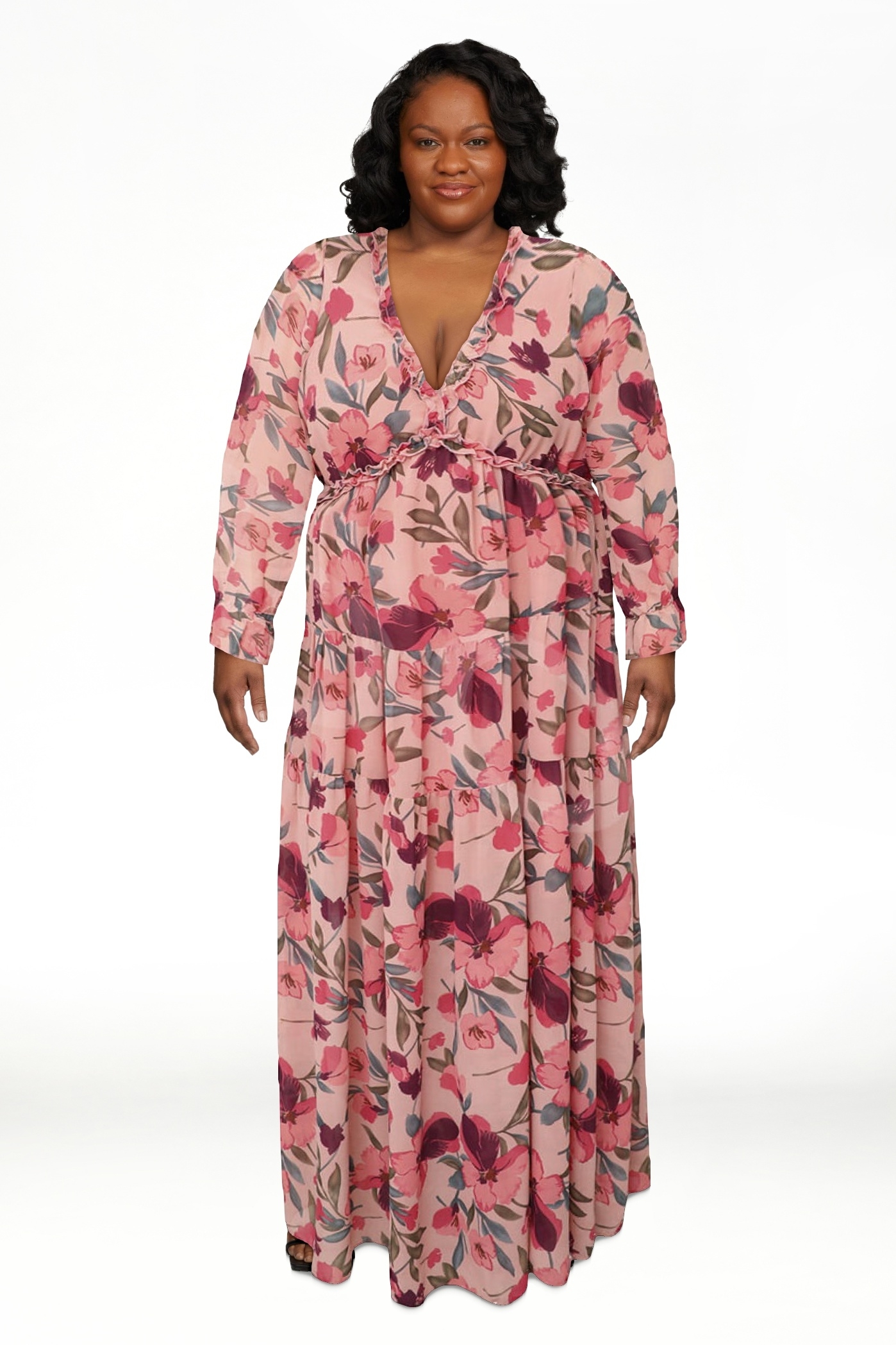 Model in a floral wrap dress standing against a white background