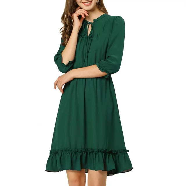 model in a casual green knee-length dress with ruffled hem and tie at neckline
