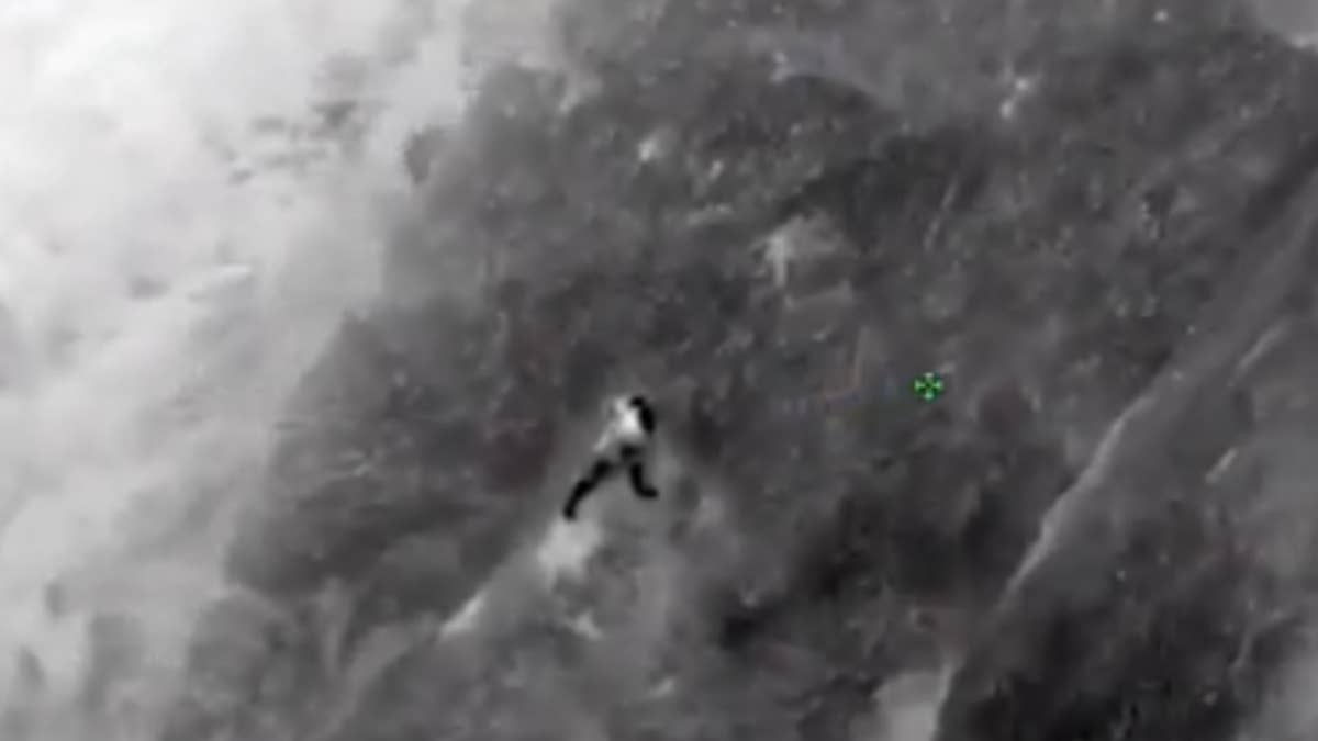 The man fell down 50 feet from a cliff and hung on to a gravel rock face until help arrived.