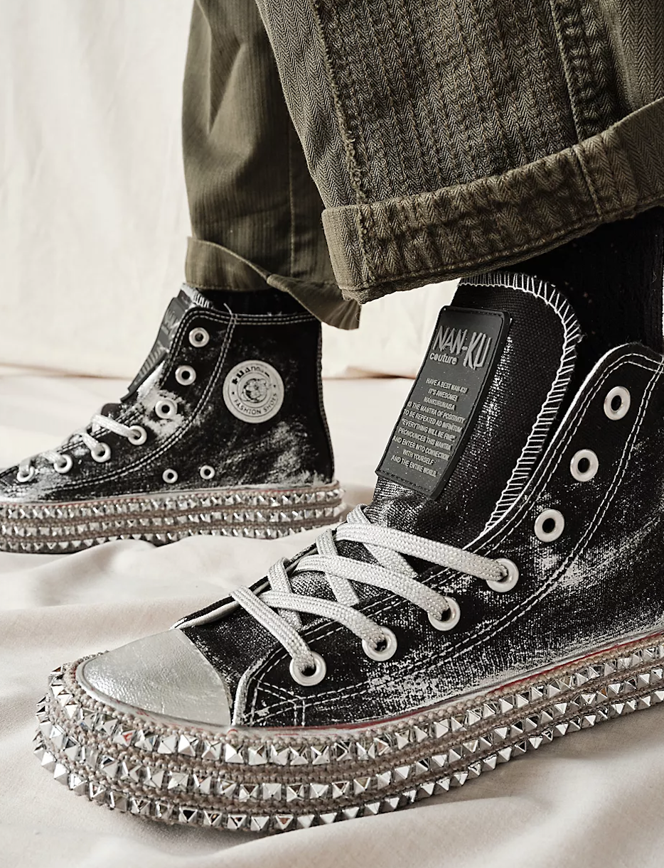 Close-up of bedazzled high-top sneakers with unique textures, suitable for an edgy fashion statement