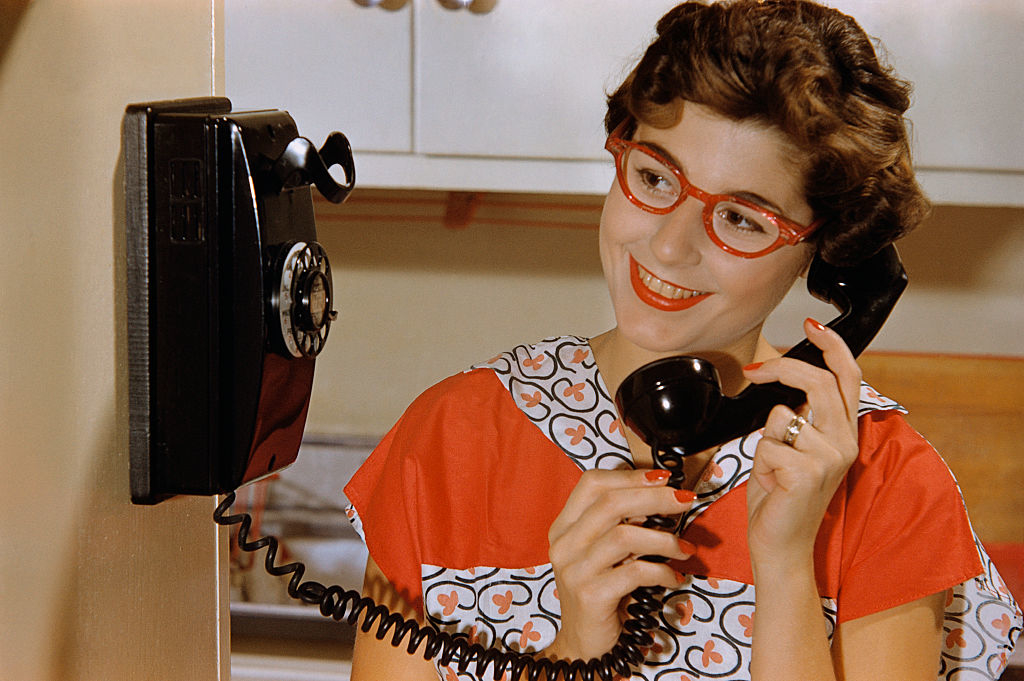 Woman talking on rotary phone