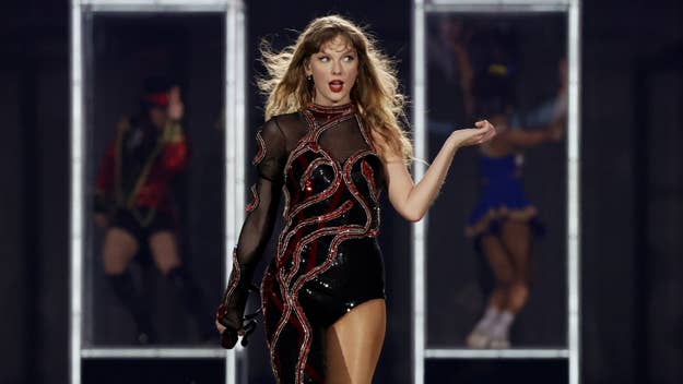 Taylor Swift performing on stage in an embellished black outfit