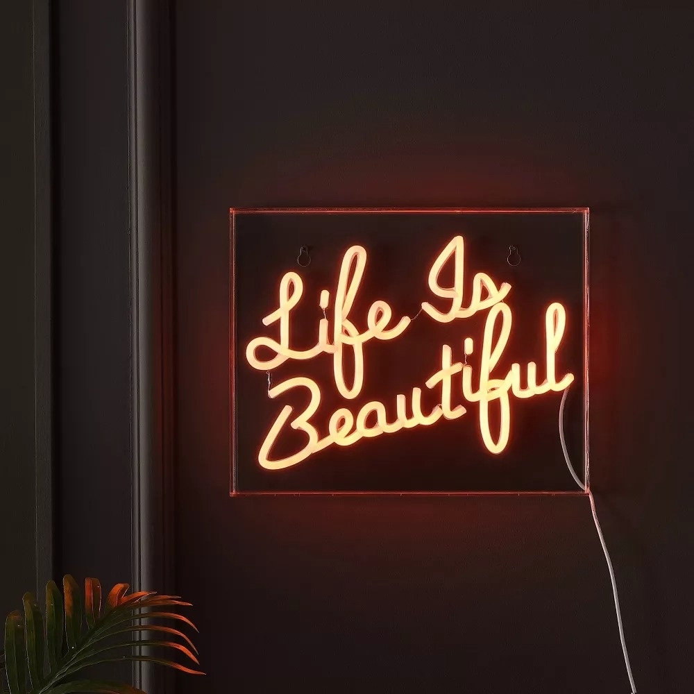 Neon sign with the inscription &quot;Life Is Beautiful&quot; for home decor