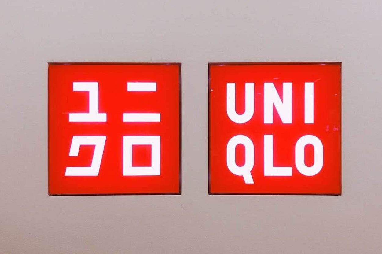 Two Uniqlo brand logo signs displayed on a wall