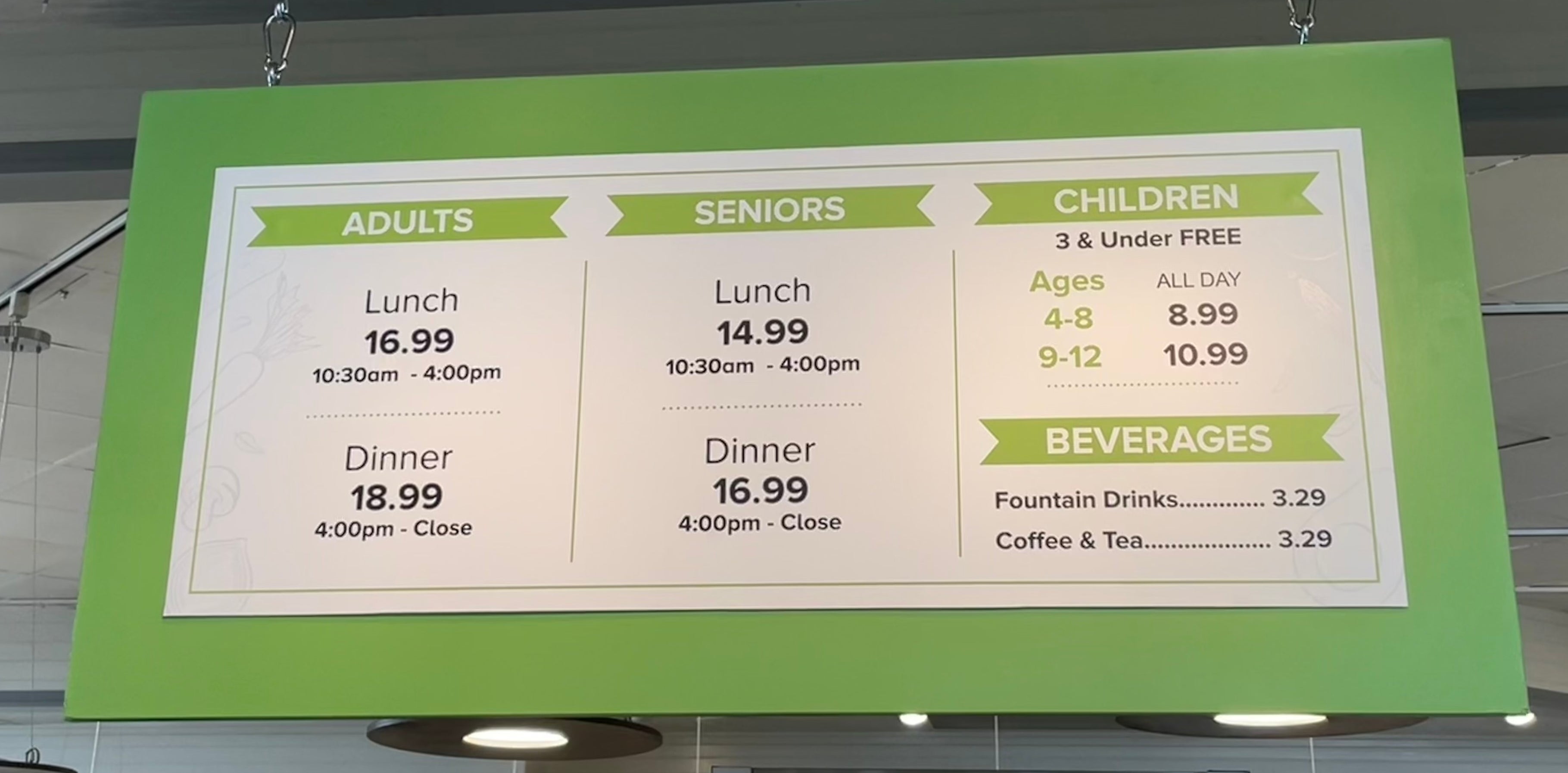 Menu sign with prices for adults, seniors, and children for lunch and dinner; includes beverage prices