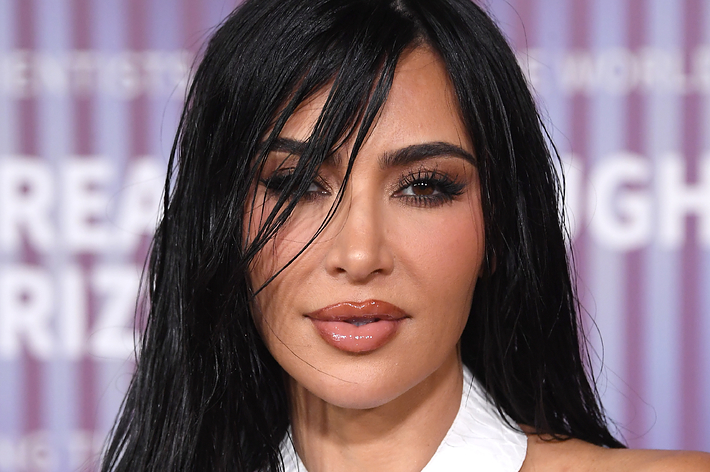 Portrait of Kim Kardashian in a white crisscross halter top at an event