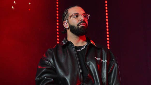 Drake in a black leather jacket performing onstage