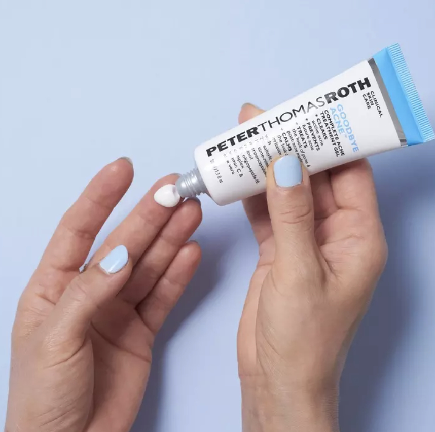 Hand squeezing lotion tube onto a fingertip