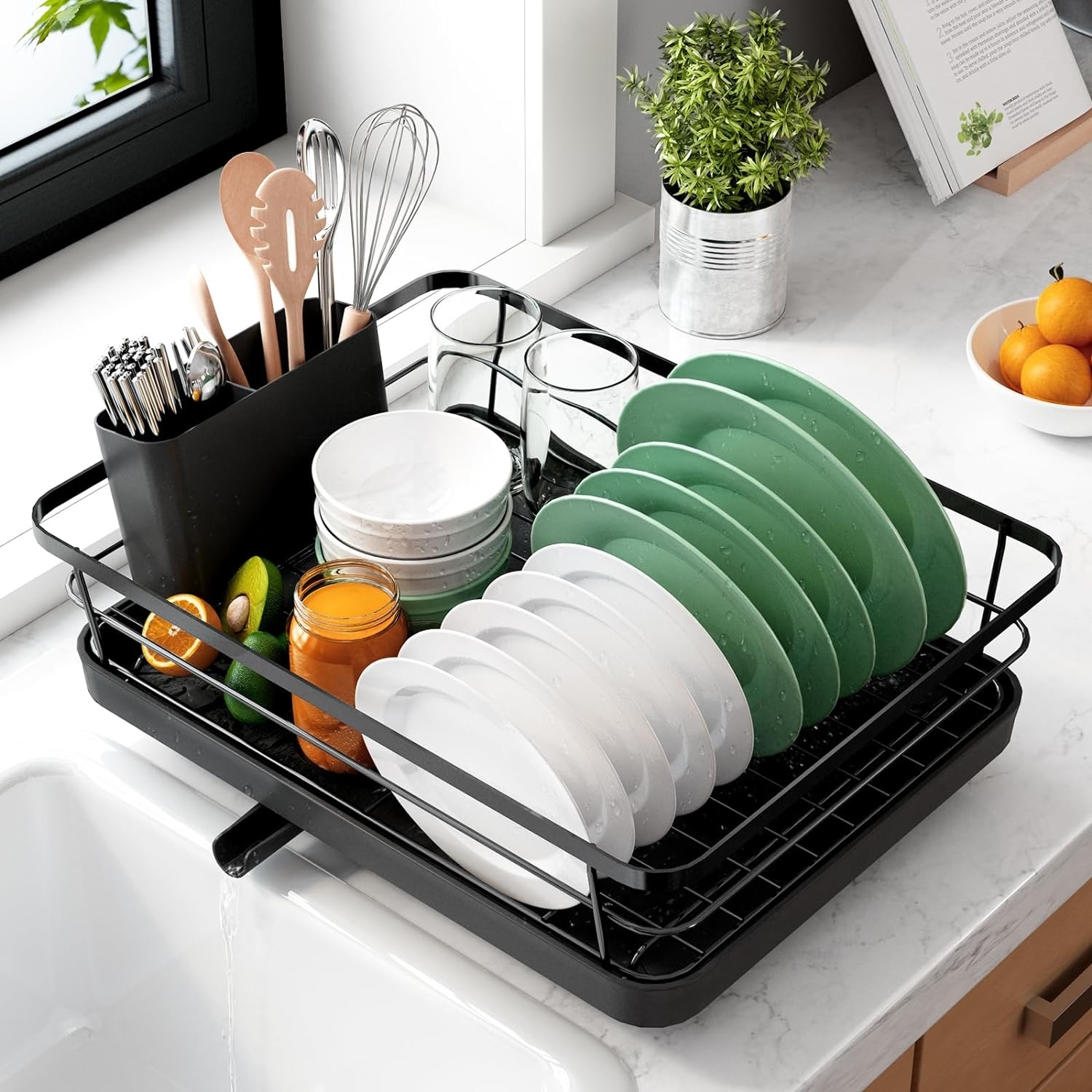 Compact dish rack on a kitchen counter holding clean dishes and utensils