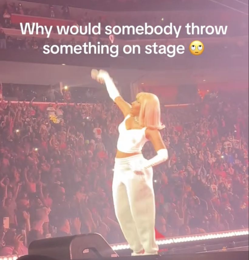 Nicki Minaj on stage with text &quot;Why would somebody throw something on stage ?&quot; expressing surprise