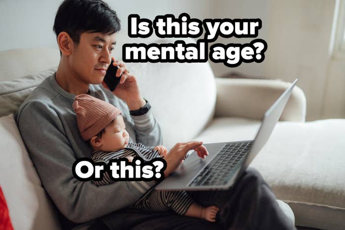 Man sitting with baby on lap, using laptop and talking on phone