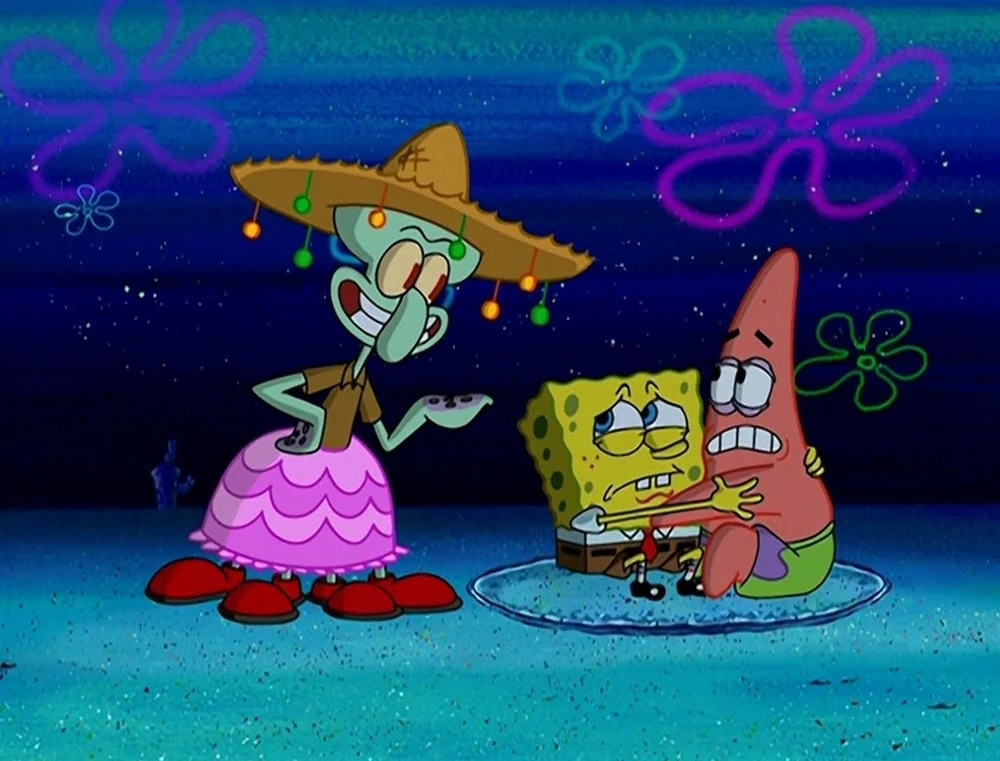 Squidward in a sombrero and dress, SpongeBob in a poncho, and Patrick under a spotlight at night