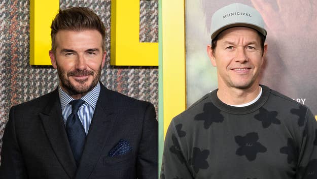 David Beckham in a tailored suit and tie, Mark Wahlberg in a casual printed top and cap