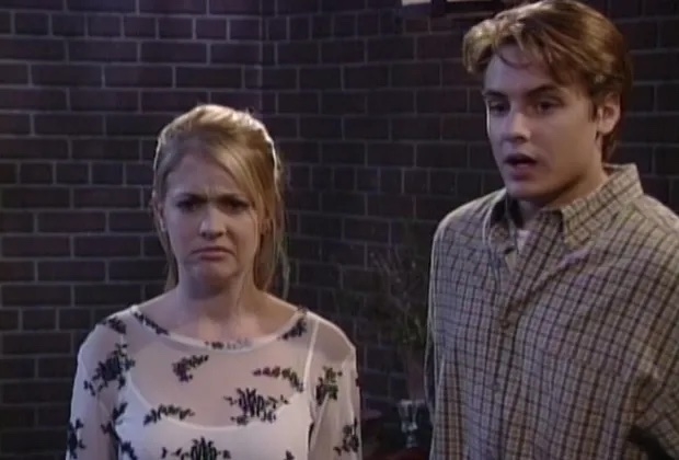 Two actors portraying confusion and surprise in a scene from a TV show
