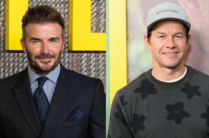 David Beckham in a suit and tie; Mark Wahlberg in a casual shirt and cap