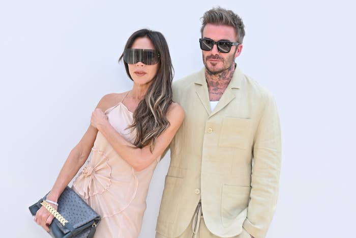 Victoria Beckham is wearing a ruched dress as she poses with David Beckham, who&#x27;s wearing a casual suit, on the red carpet