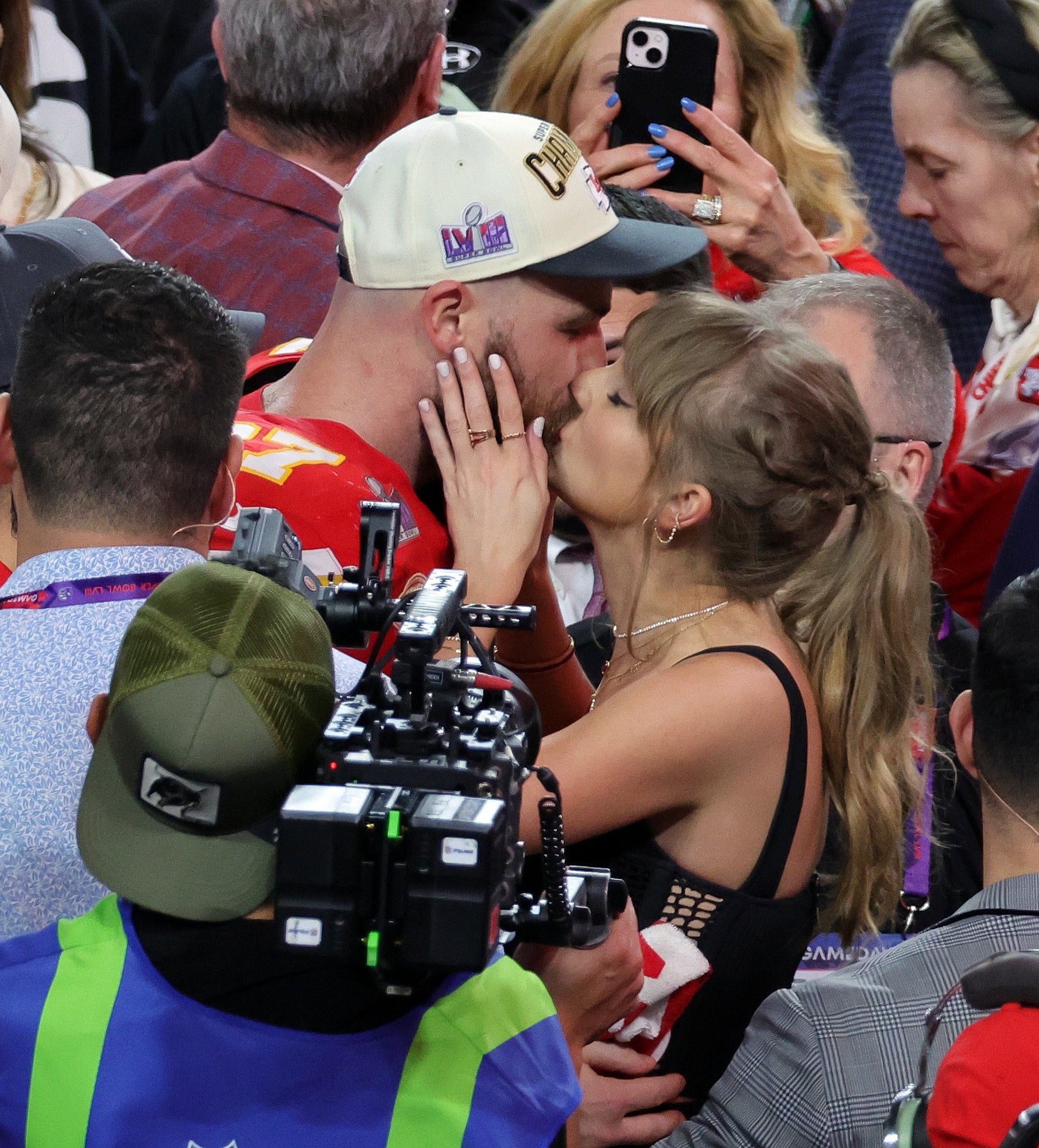 Travis and Taylor kissing after a Chiefs game
