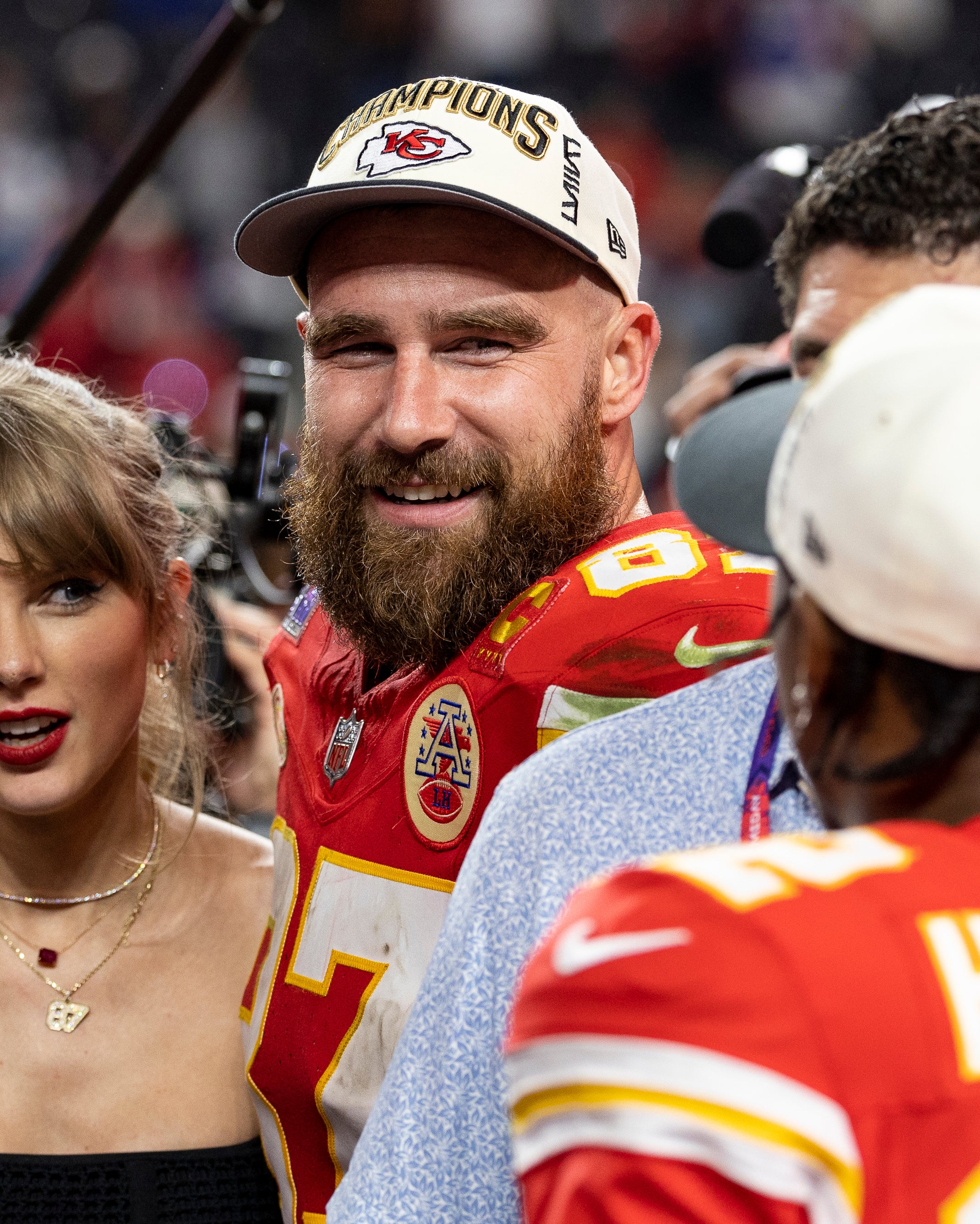 Taylor Swift standing next to Travis Kelce after one of his football games