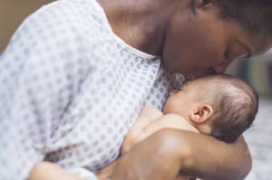 Woman kisses her baby's forehead as they cuddle closely
