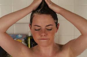 Emma Stone forming her hair into a mohawk in the shower as Olive in Easy A