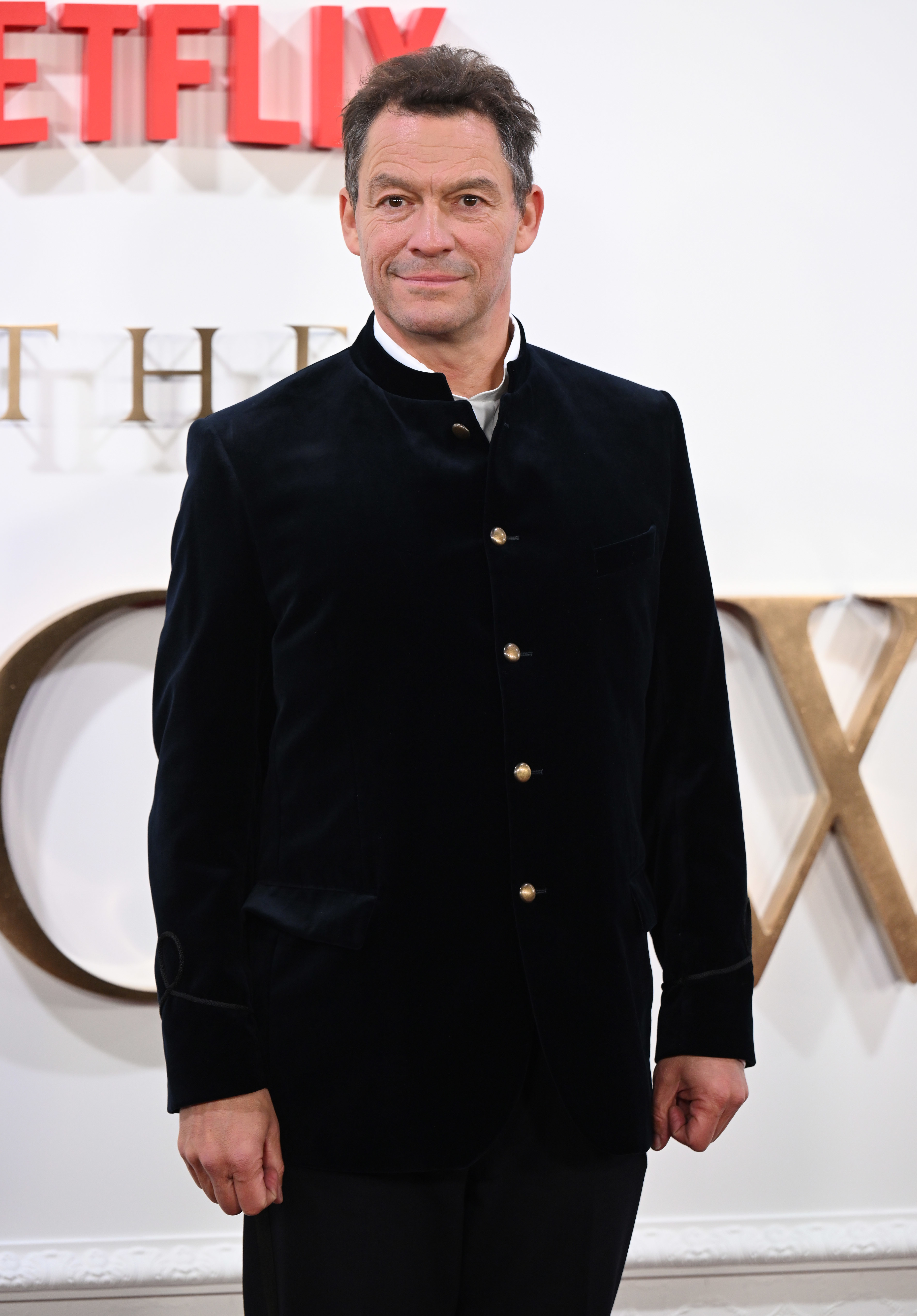 Dominic West in a velvet suit at The Crown event