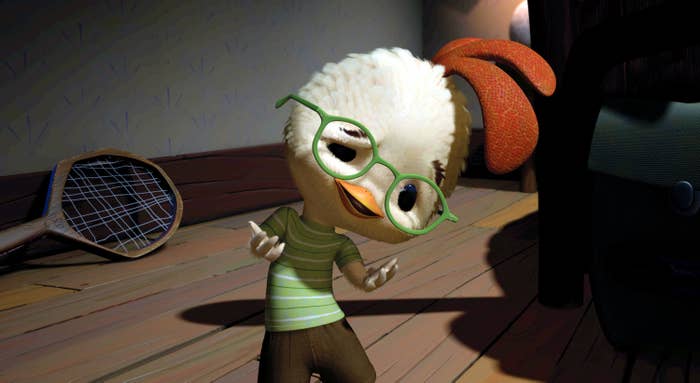 Animated character Chicken Little in a striped shirt, holding a pair of glasses near a tennis racket