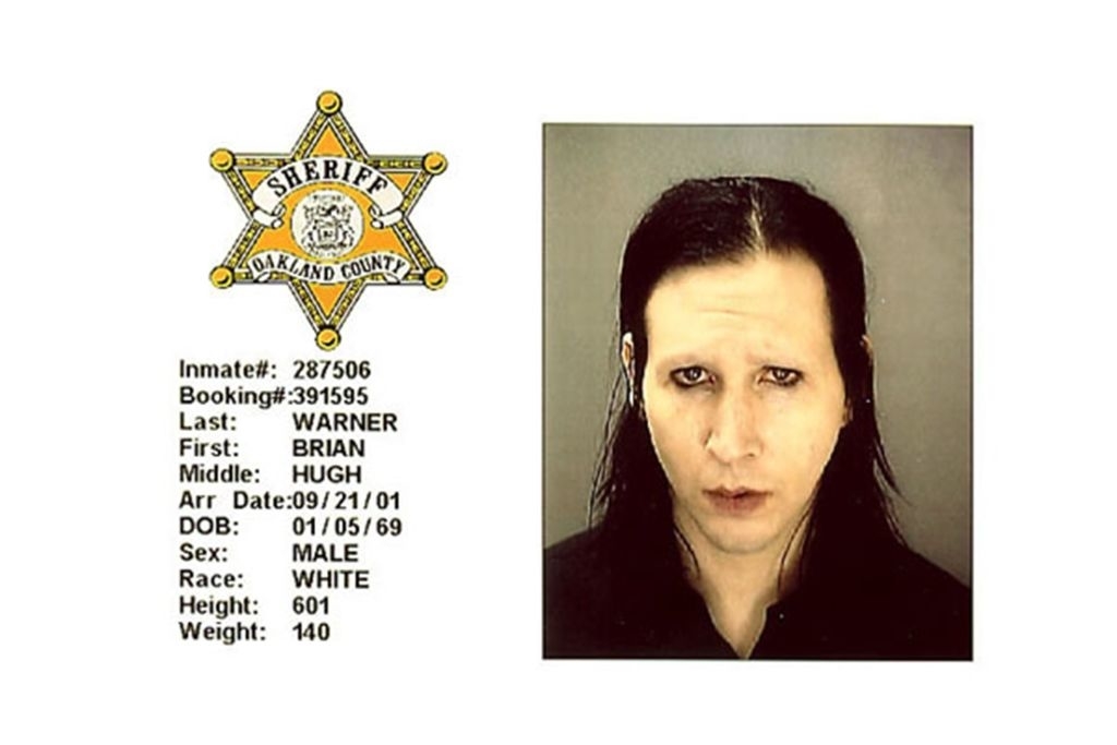 Mugshot of Brian Warner with sheriff&#x27;s badge and booking details