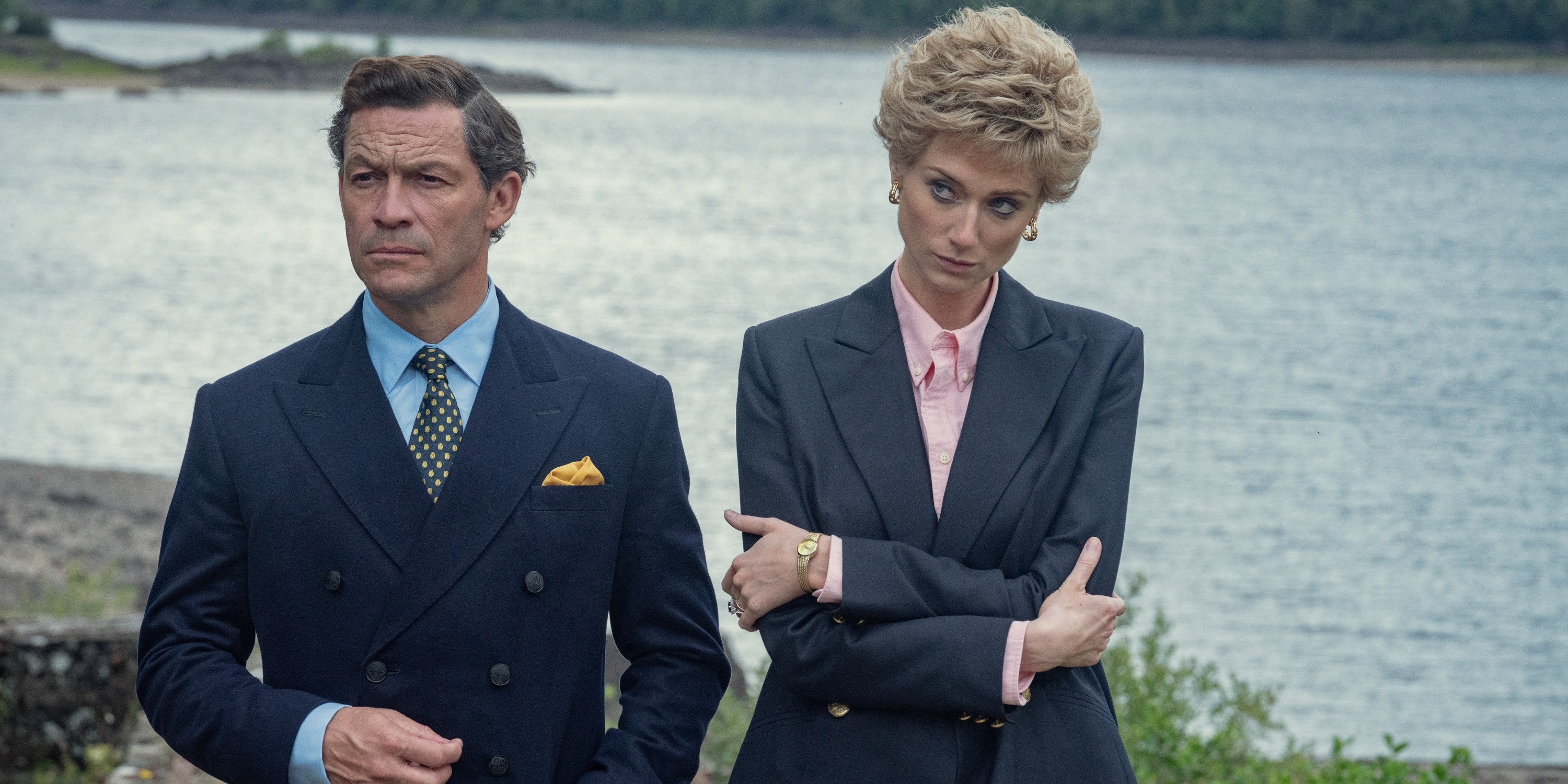 Dominic and Elizabeth Debicki stand next to each other by the ocean during their portrayals as Prince Charles and Princess Diana