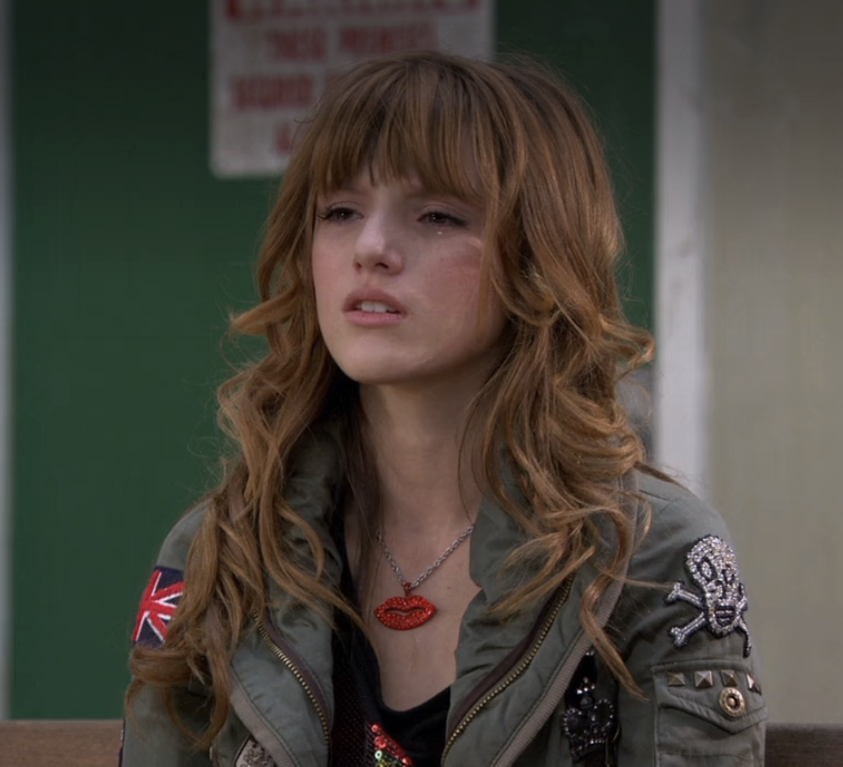 Bella as Cene with layered hair, wearing a detailed bomber jacket and a lips necklace in a scene from &quot;Shake It Up&quot;