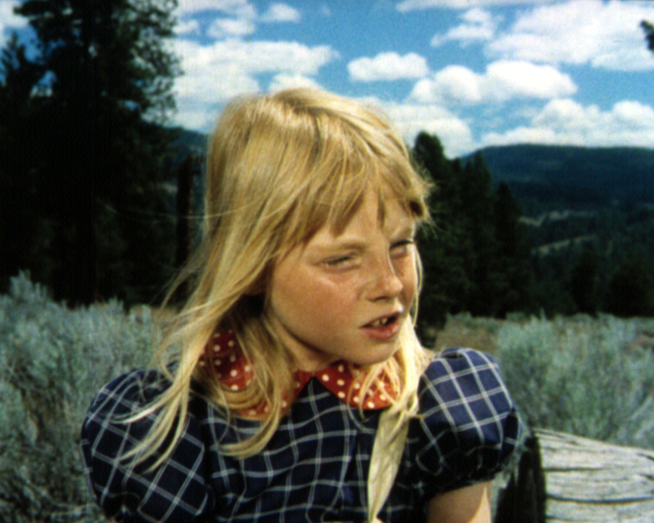 YoungJodie in braids and a checkered dress with a polka-dot scarf outdoors in a scene from &quot;Napoleon and Samantha&quot;