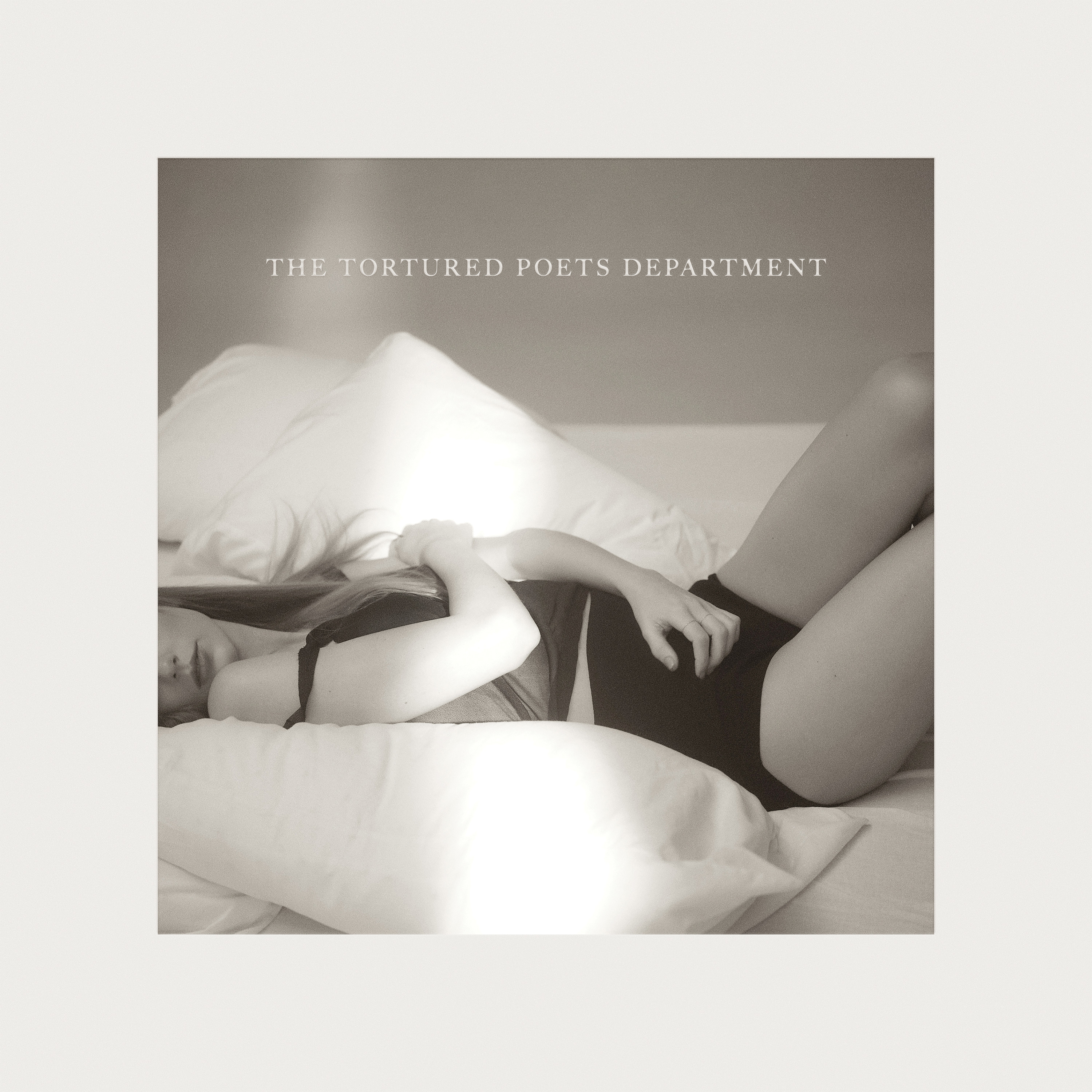 Album cover of &#x27;The Tortured Poets Department&#x27; with an Taylor Swift posing pensively on a bed