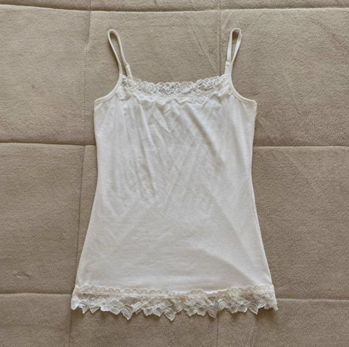White lace-trimmed camisole on a quilted background
