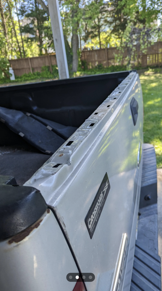 Close-up of a damaged car rooftop cargo box with the &quot;CARGOLOCS&quot; brand visible