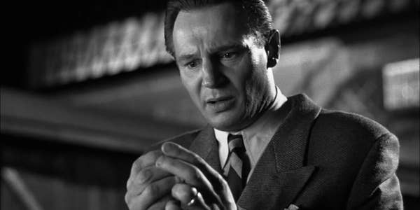 Actor portraying emotion, in classic suit and tie, in a black-and-white film scene