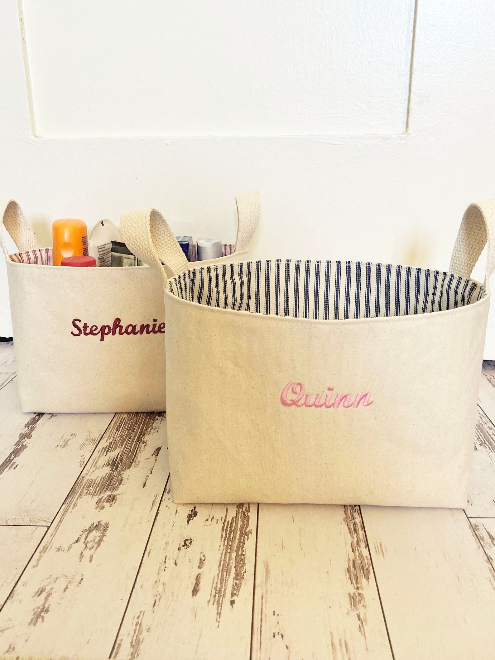 Two personalized fabric totes with &quot;Stephanie&quot; and &quot;Quinn&quot; embroidered on them