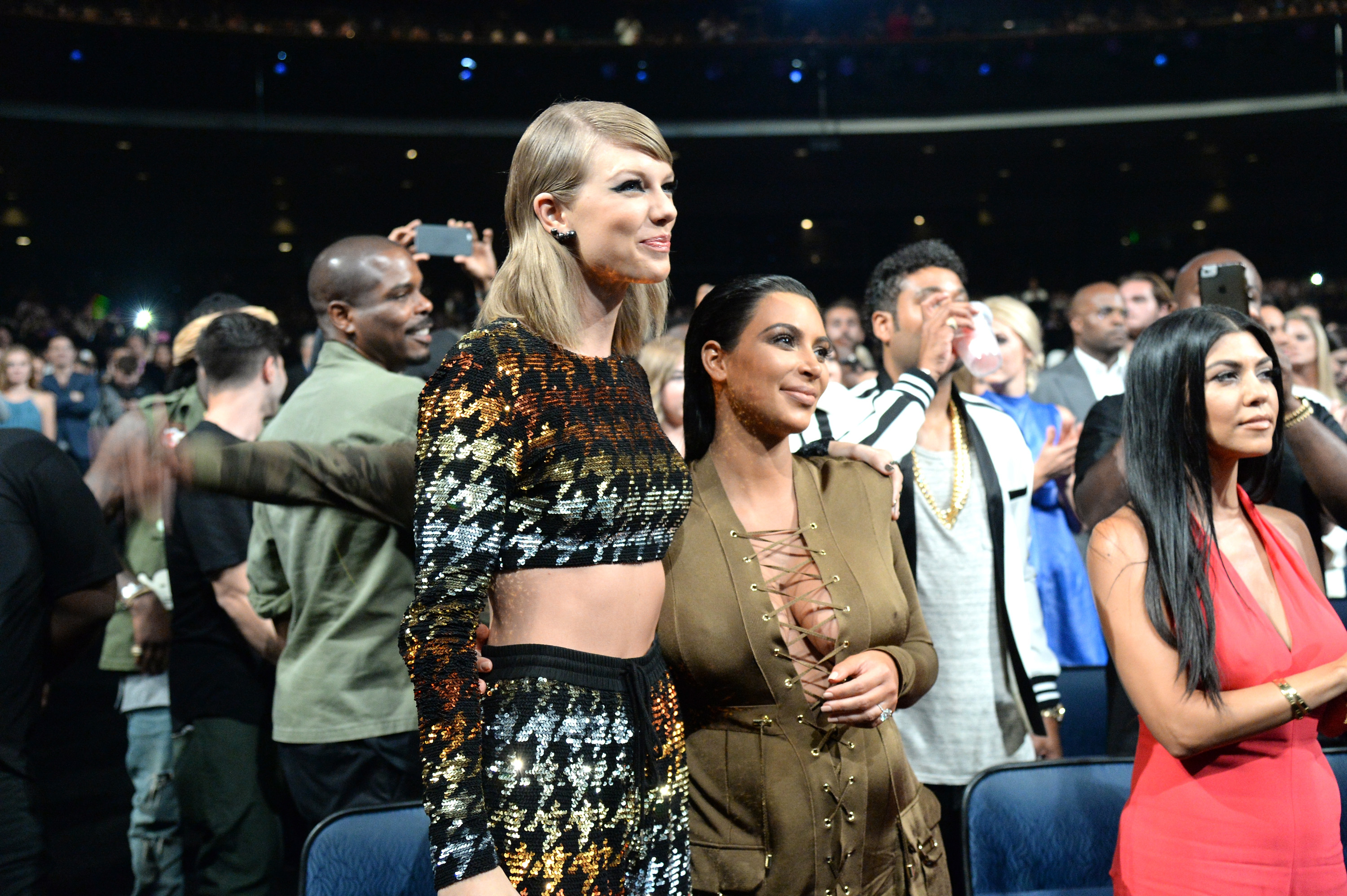 Taylor and Kim standing together enjoying a performance