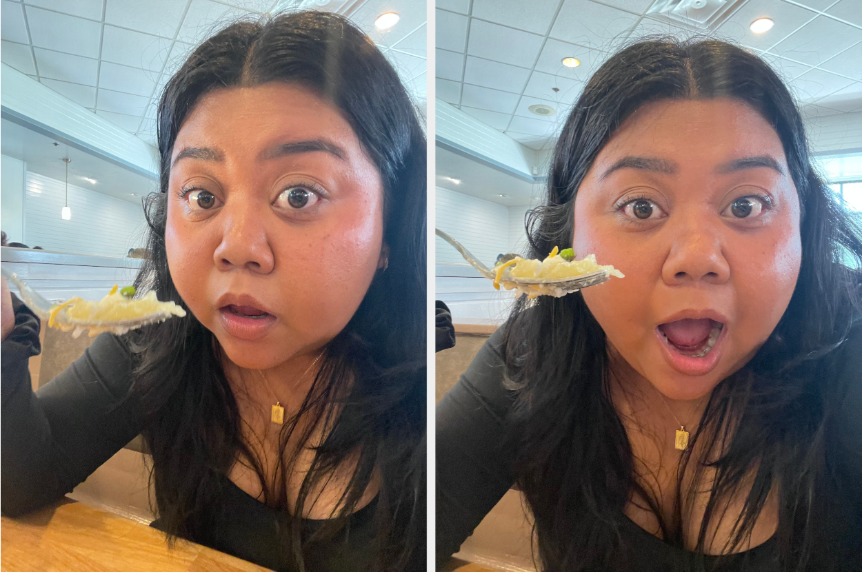 Woman with surprised expression holding a fork with food near her mouth
