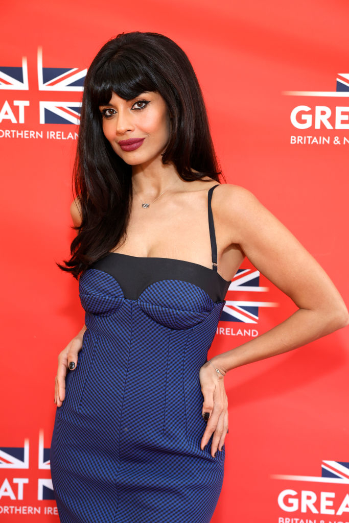 Jameela Jamil poses in a sleeveless dress with a unique bodice on the red carpet