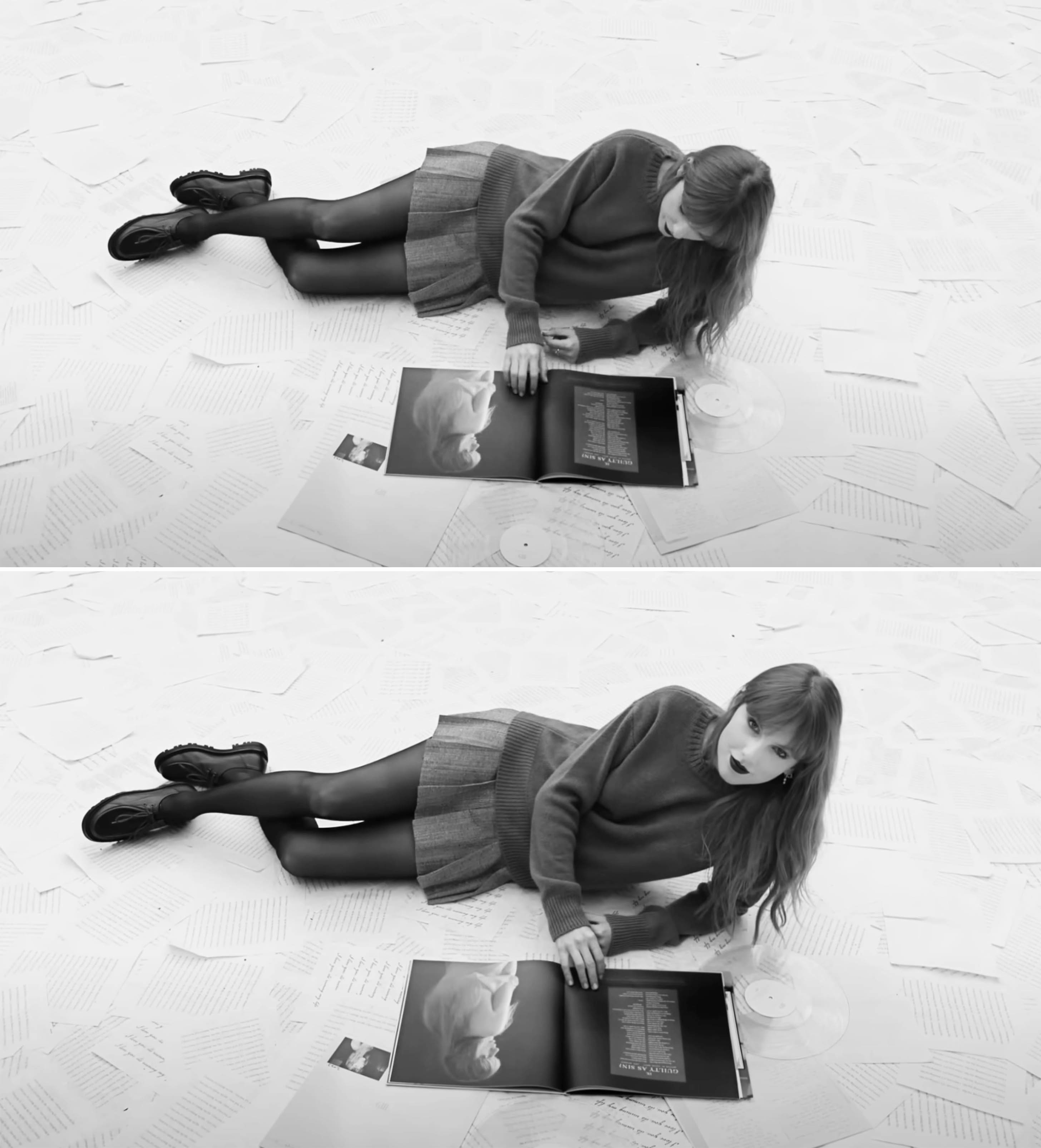 Taylor Swift sitting on floor with scattered papers, looking at open album with reflective expression