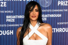 Kim Kardashian in a white crossover neckline dress at the Breakthrough Prize ceremony