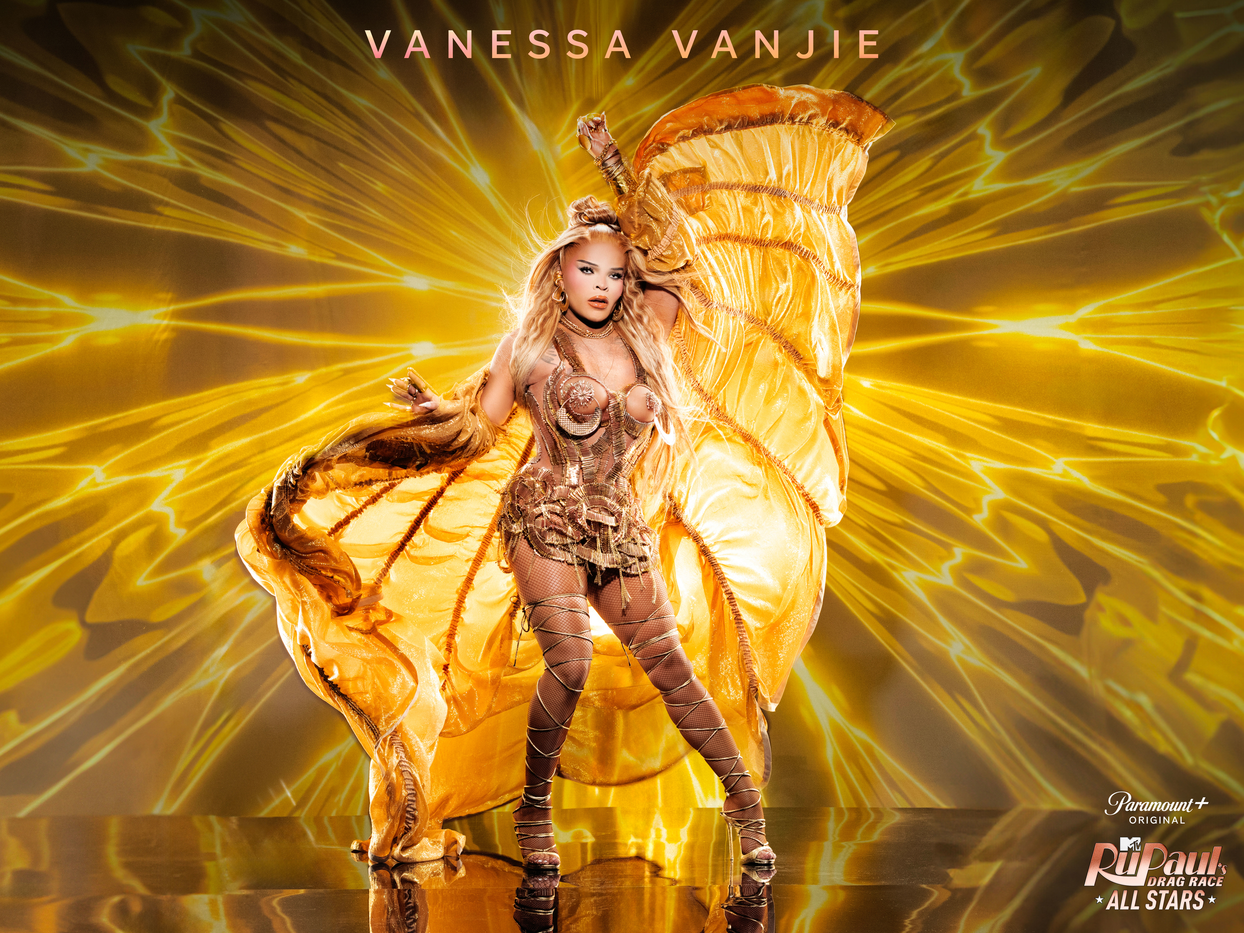 Vanessa Vanjie in a striking performance outfit with large wing-like accessories