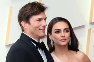 Ashton Kutcher and Mila Kunis in formal attire at an event