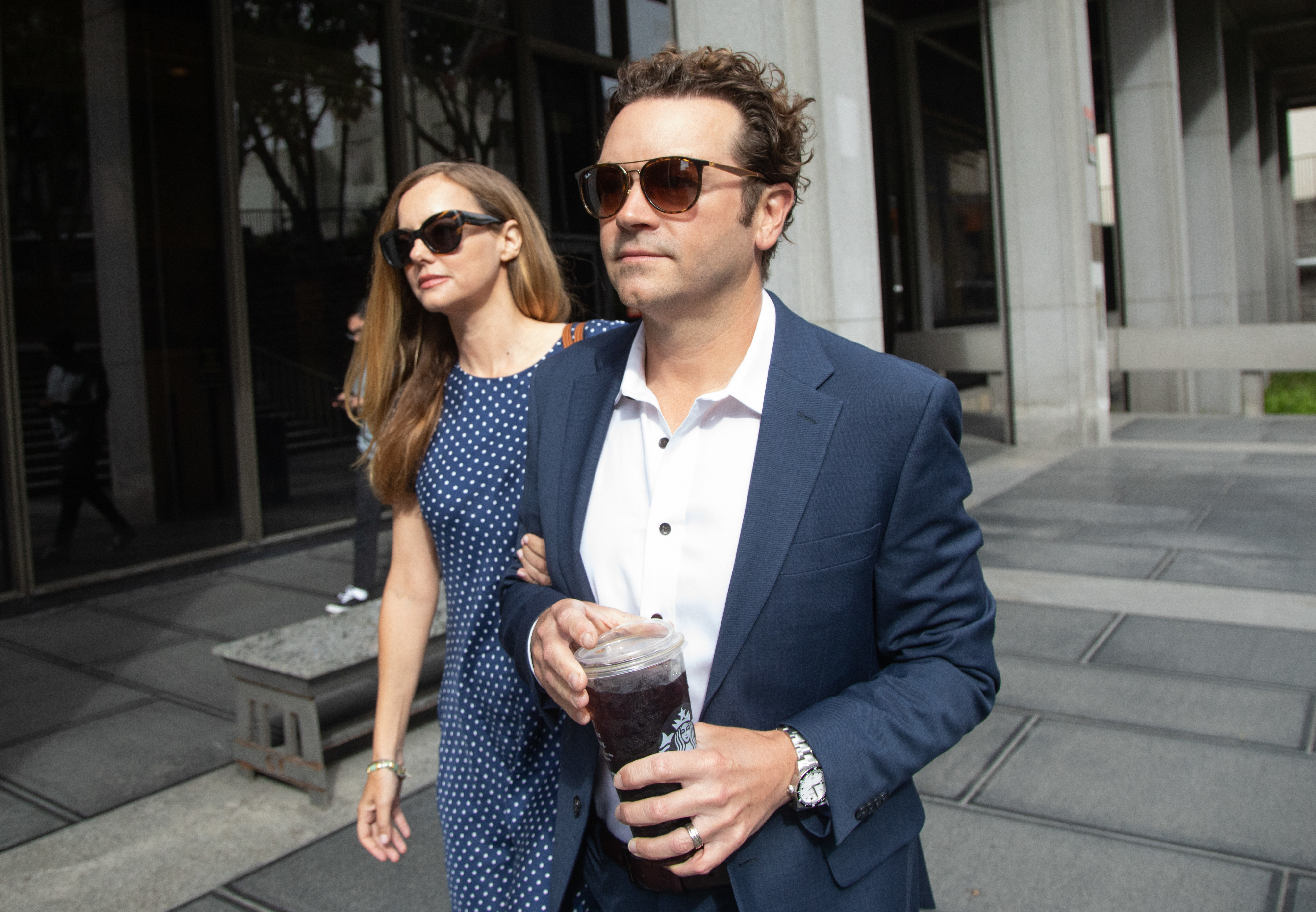 Closeup of Danny Masterson and his partner walking outside
