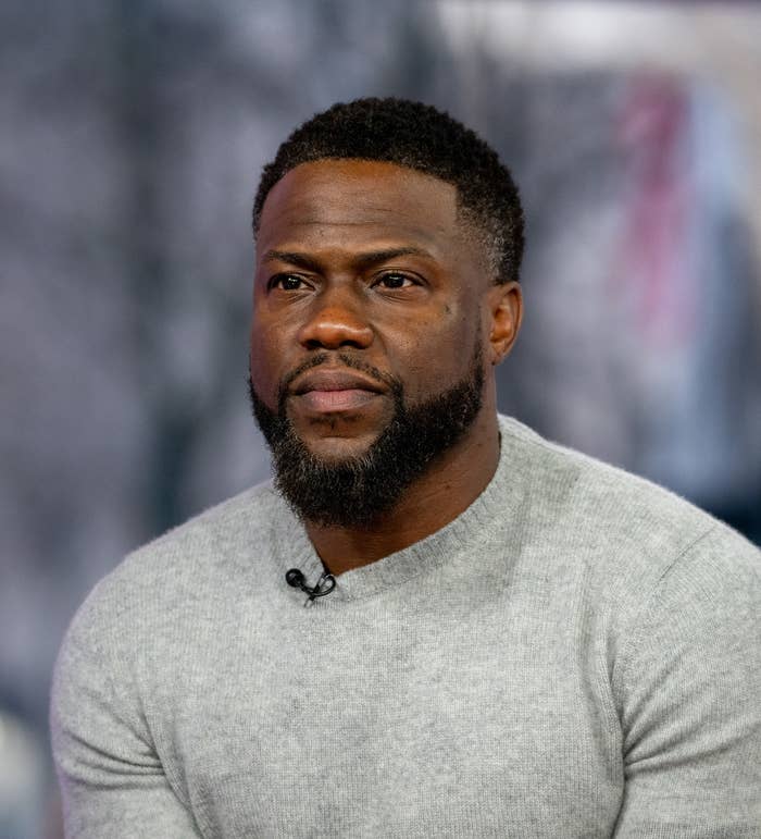 A closeup of Kevin Hart in a sweater during an interview