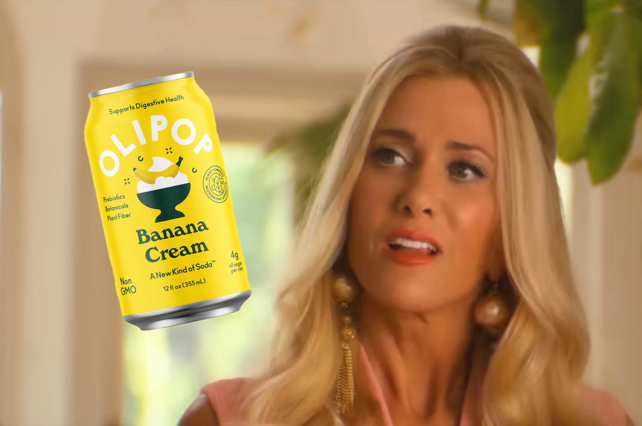 Kristen Wigg looks surprised holding with a can of OLIPOP Banana Cream soda overlaid.